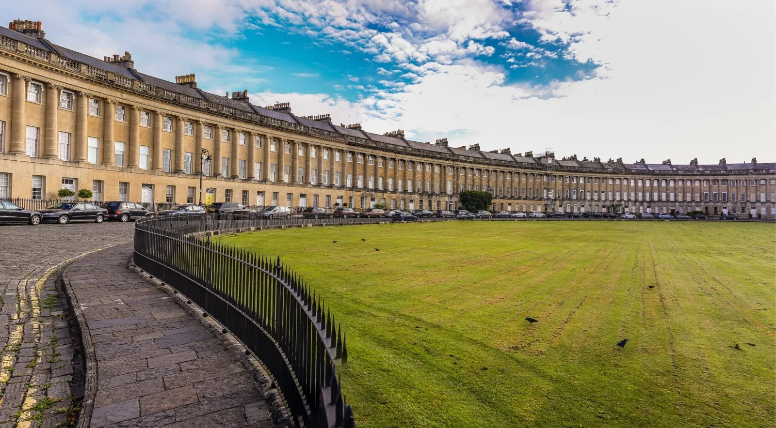 The sweeping honey-stone arc of the Royal Crescent in Bath, a masterpiece of Georgian architecture, above its broad lawn